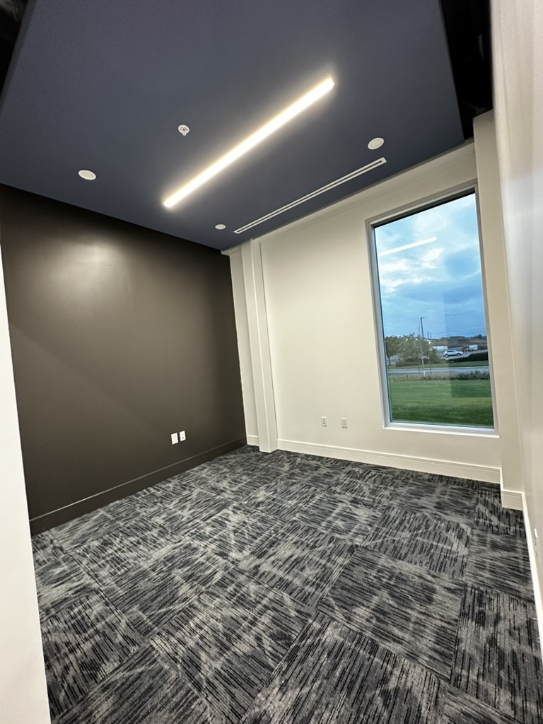 Commercial room with dark ceiling and accent wall