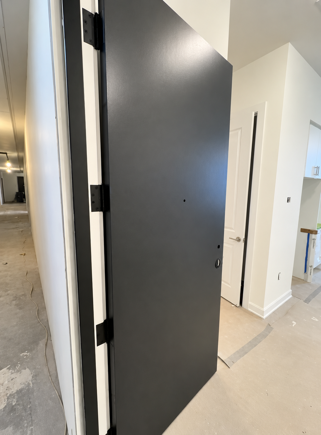 Charcoal painted door in a condominium suite under construction